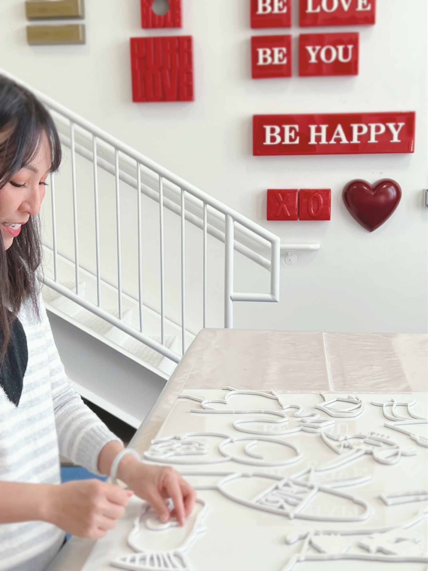 Jeanne Chang in the art studio creating acrylic wall art